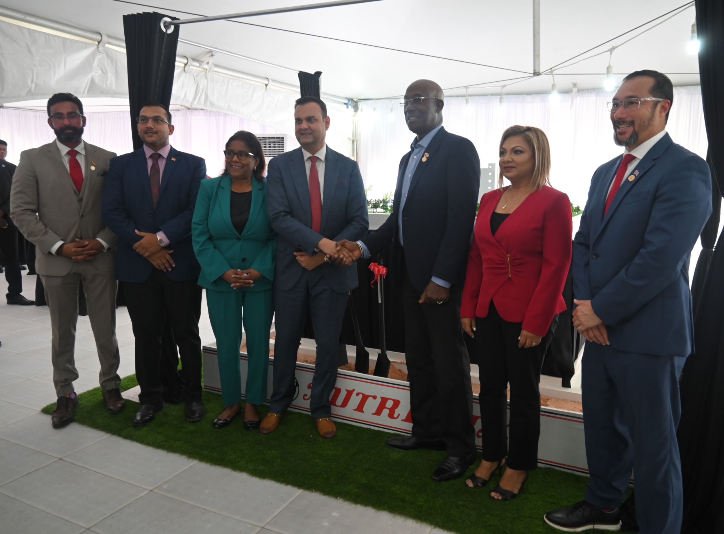 Nutrimix Sod turning Ceremony. Prime Minister Keith Rowley shakes hands with Mr. Ronnie Mohammed, CEO of the Nutrimix Group of Companies, alongside (from left to right) Senator the Hon. Richie Sookhai, Minister in the Ministry of Works and Transport; Senator the Hon. Avinash G. Singh, Minister in the Ministry of Agriculture, Land and Fisheries; Senator the Hon. Paula Gopee-Scoon, Minister of Trade and Industry; Mrs. Mohammed Director, Nutrimix Group of Companies, and Hon. Stuart Young S.C., Minister of Energy and Energy Industries and Minister in the Office of the Prime Minister