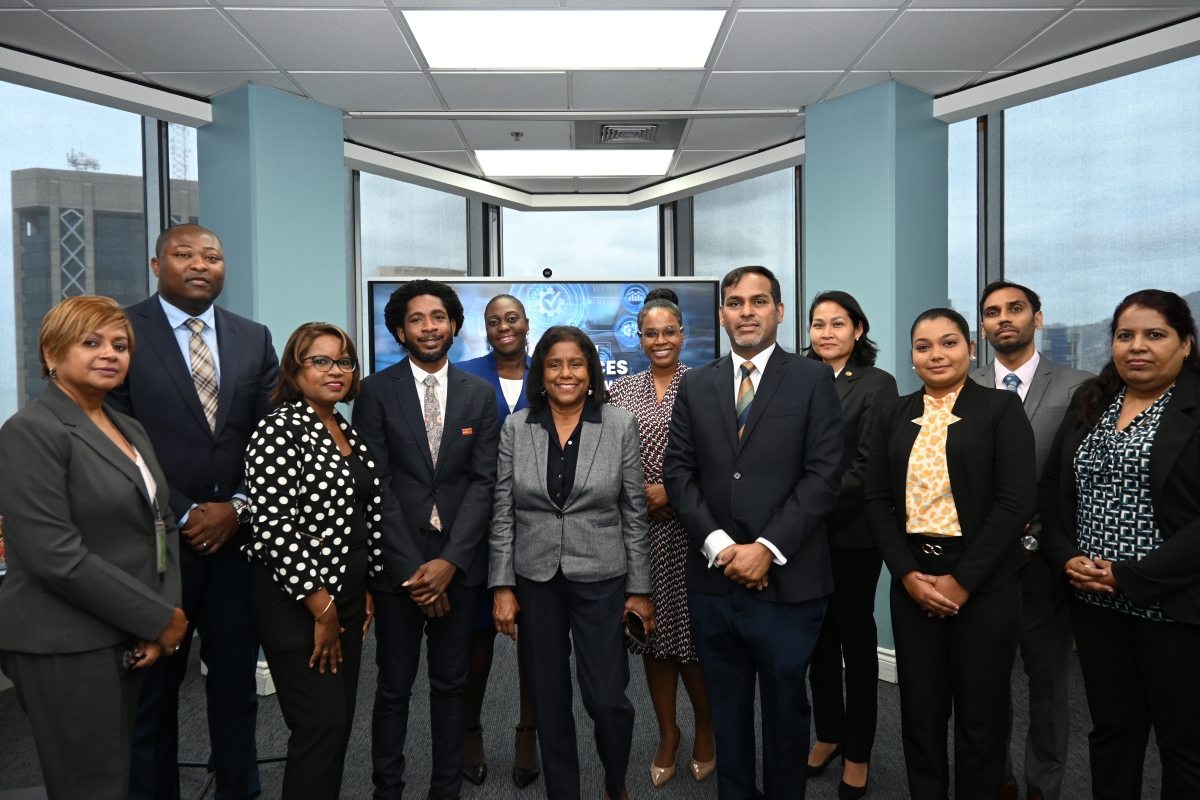 Senator the Honourable Paula Gopee-Scoon, Minister of Trade and Industry, at center, accompanied by Permanent Secretary in the Ministry of Trade and Industry Randall Karim (right), Permanent Secretary in the Ministry of Digital Transformation, Cory Belfon (second from left), and representatives of Crimson Logic, Trinidad Tourism Limited, and the Trade Licence and TTBizLink units of the Ministry of Trade and Industry.