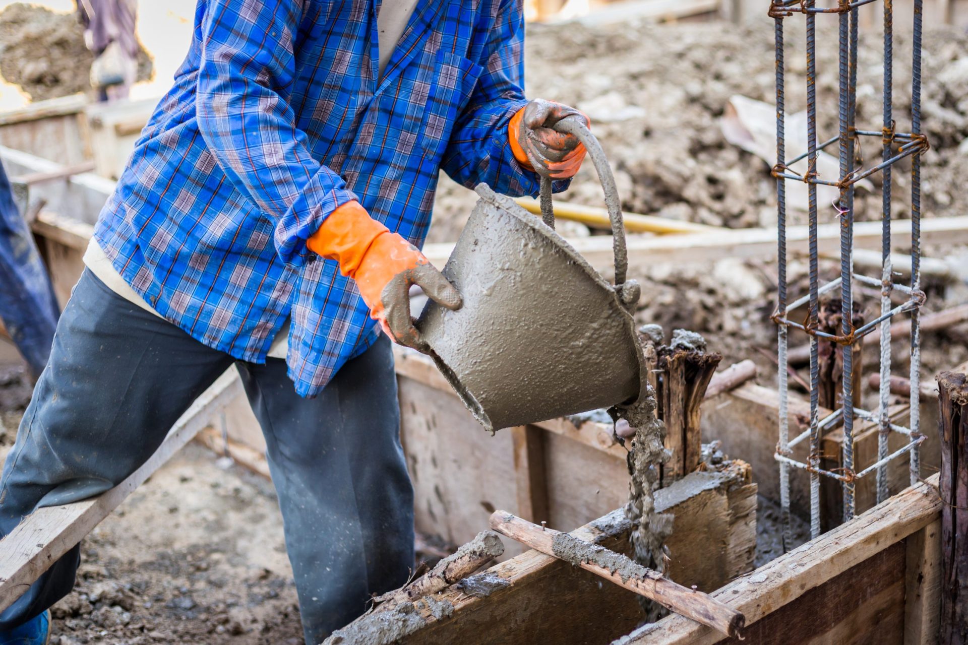 worker mixing cement mortar plaster for construction