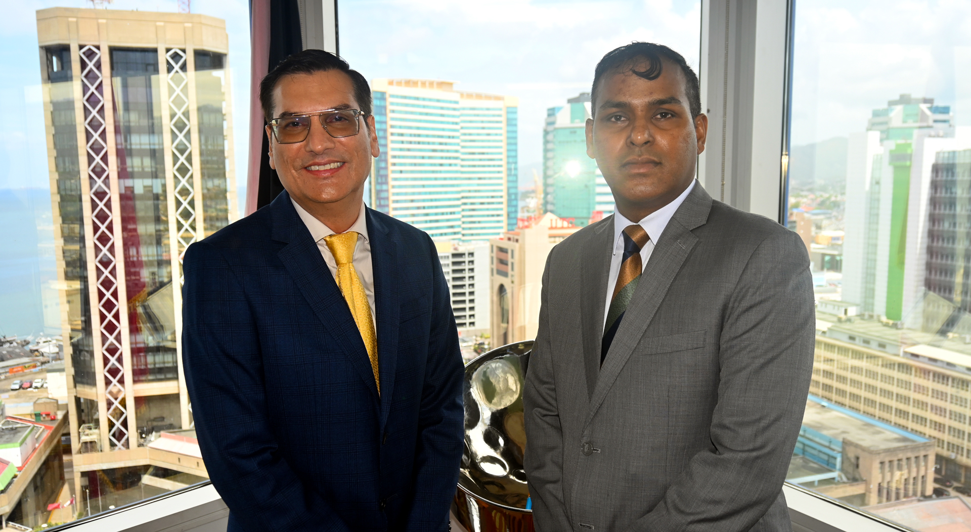 (left)Dr. Colin Neil Gosine, Parliamentary Secretary in the Ministry of Trade, Investment and Tourism, with (right) Mr. Randall Karim, Permanent Secretary in the Ministry of Trade, Investment and Tourism.