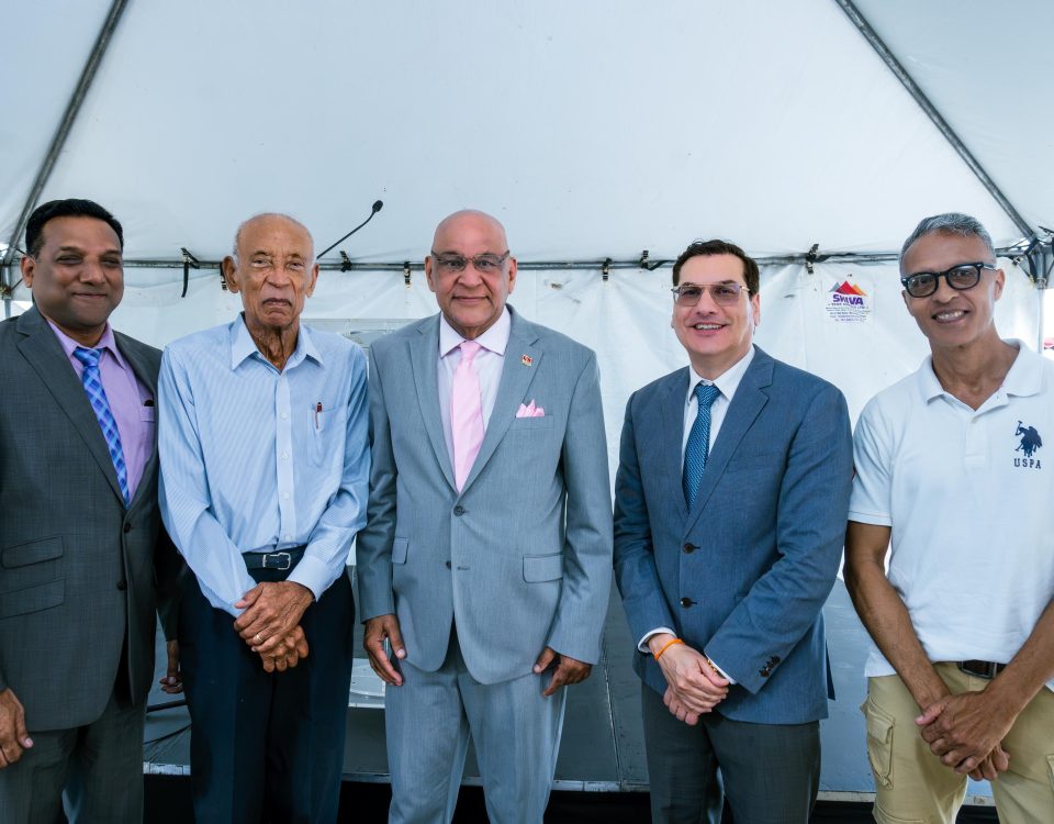 Group of of men including Senator the Honourable Satyakama Maharaj, Minister of Trade, Investment and Tourism (center) together with Dr. Colin Neil Gosine, MP, Parliamentary Secretary in the Ministry of Trade, Investment and Tourism (second from left), Mr. Anthony Pinto, Chairman of the Board of Directors, GC Resorts Ltd. (left), Mr. Ken Gordon, GC Resorts Advisor, and Dr. Kirk Meighoo, GC Resorts Director.