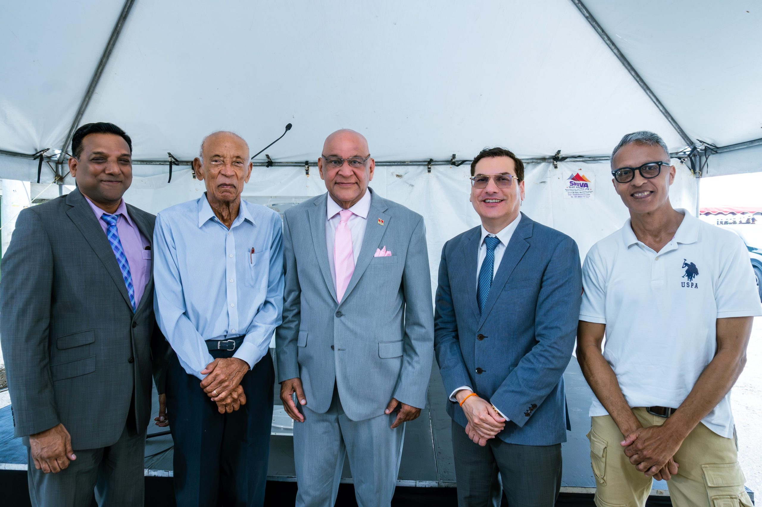 Group of of men including Senator the Honourable Satyakama Maharaj, Minister of Trade, Investment and Tourism (center) together with Dr. Colin Neil Gosine, MP, Parliamentary Secretary in the Ministry of Trade, Investment and Tourism (second from left), Mr. Anthony Pinto, Chairman of the Board of Directors, GC Resorts Ltd. (left), Mr. Ken Gordon, GC Resorts Advisor, and Dr. Kirk Meighoo, GC Resorts Director.