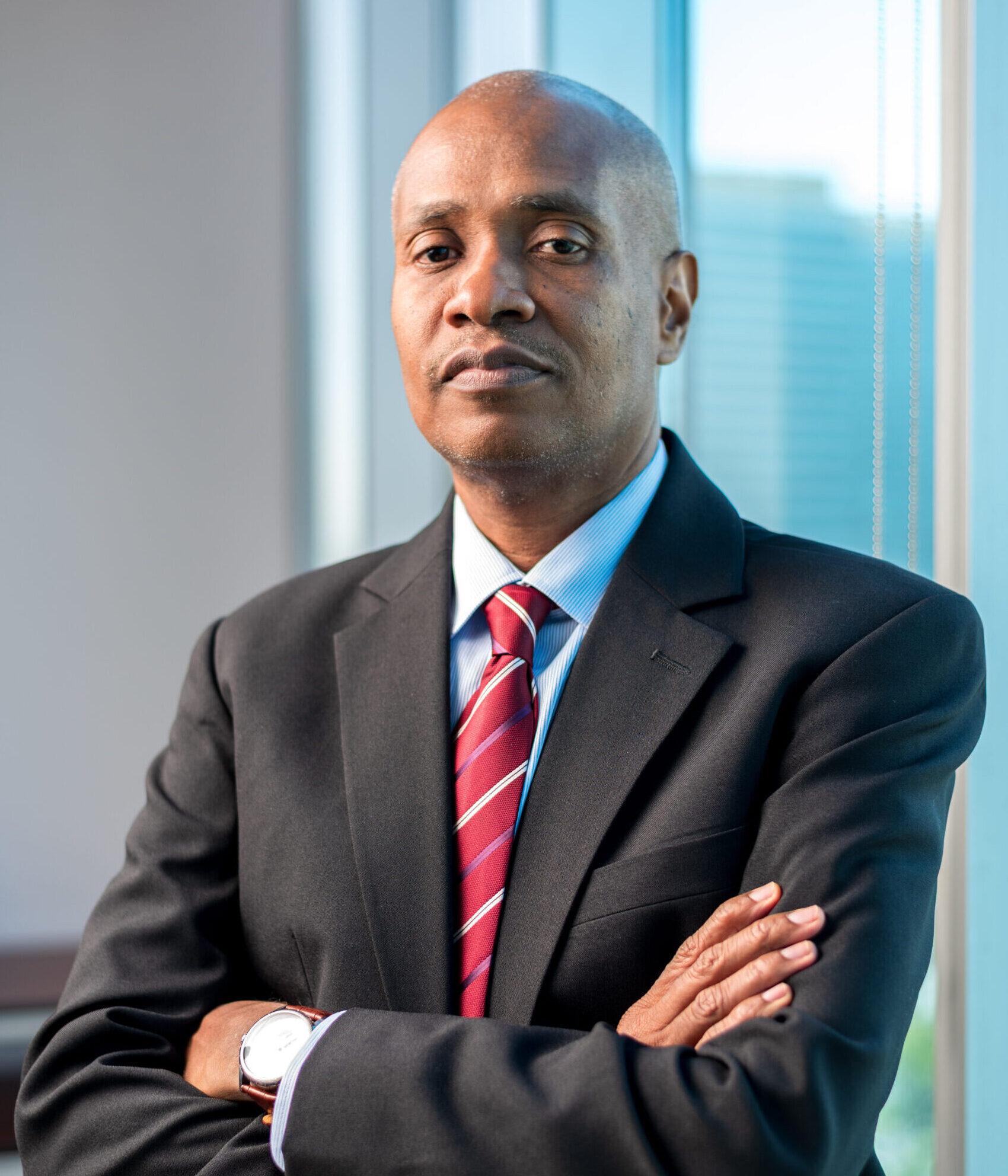 DPS Neville Alexander standing with arms folded
