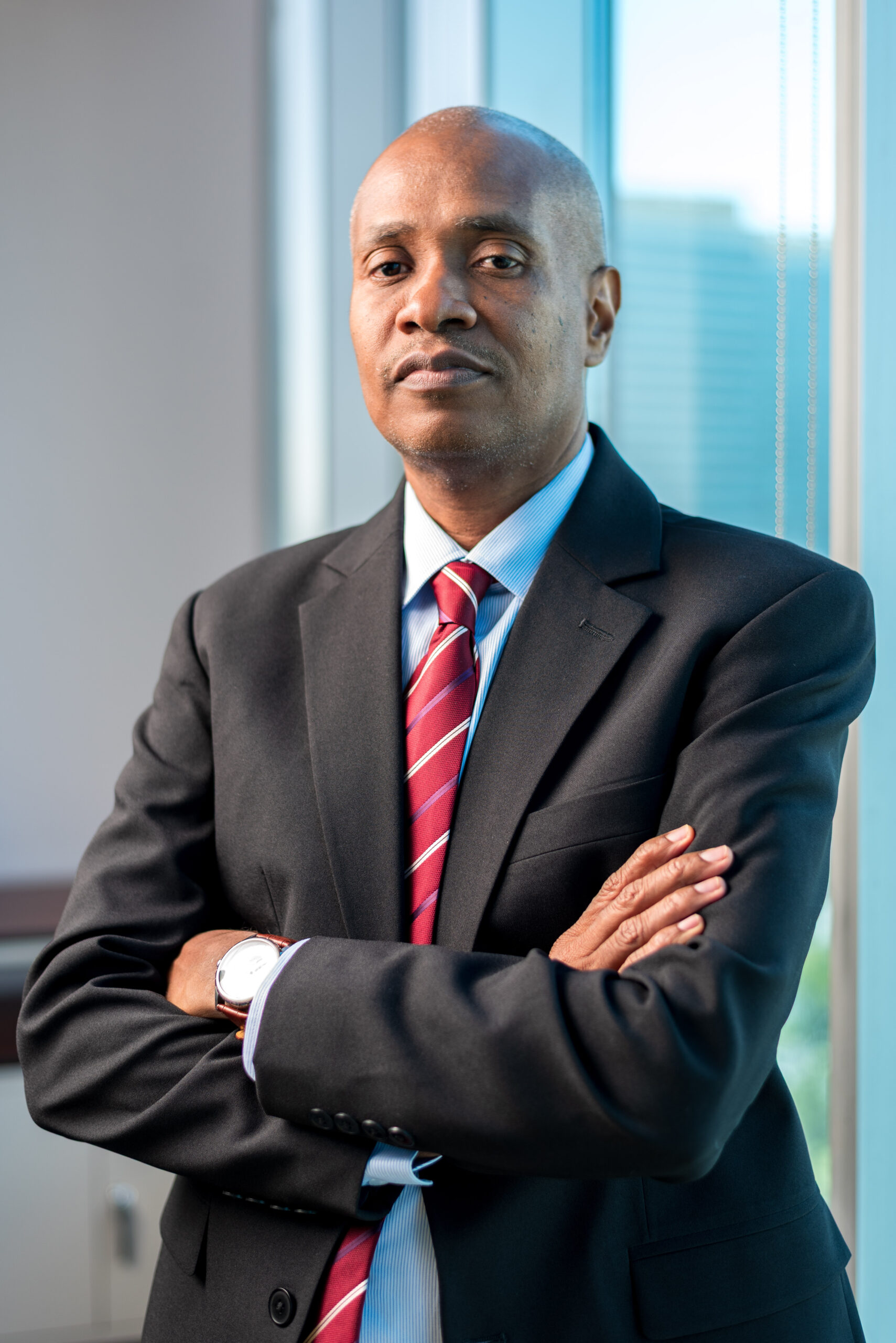 DPS Neville Alexander standing with arms folded