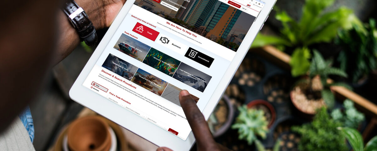 Picture of tablet and plants in background