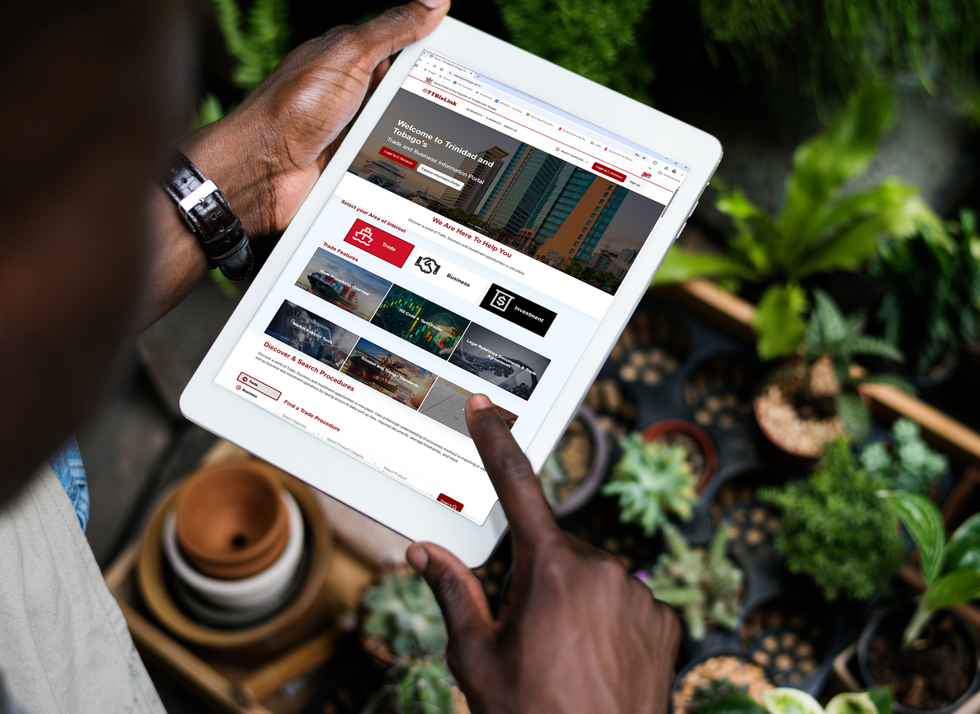 Picture of tablet and plants in background